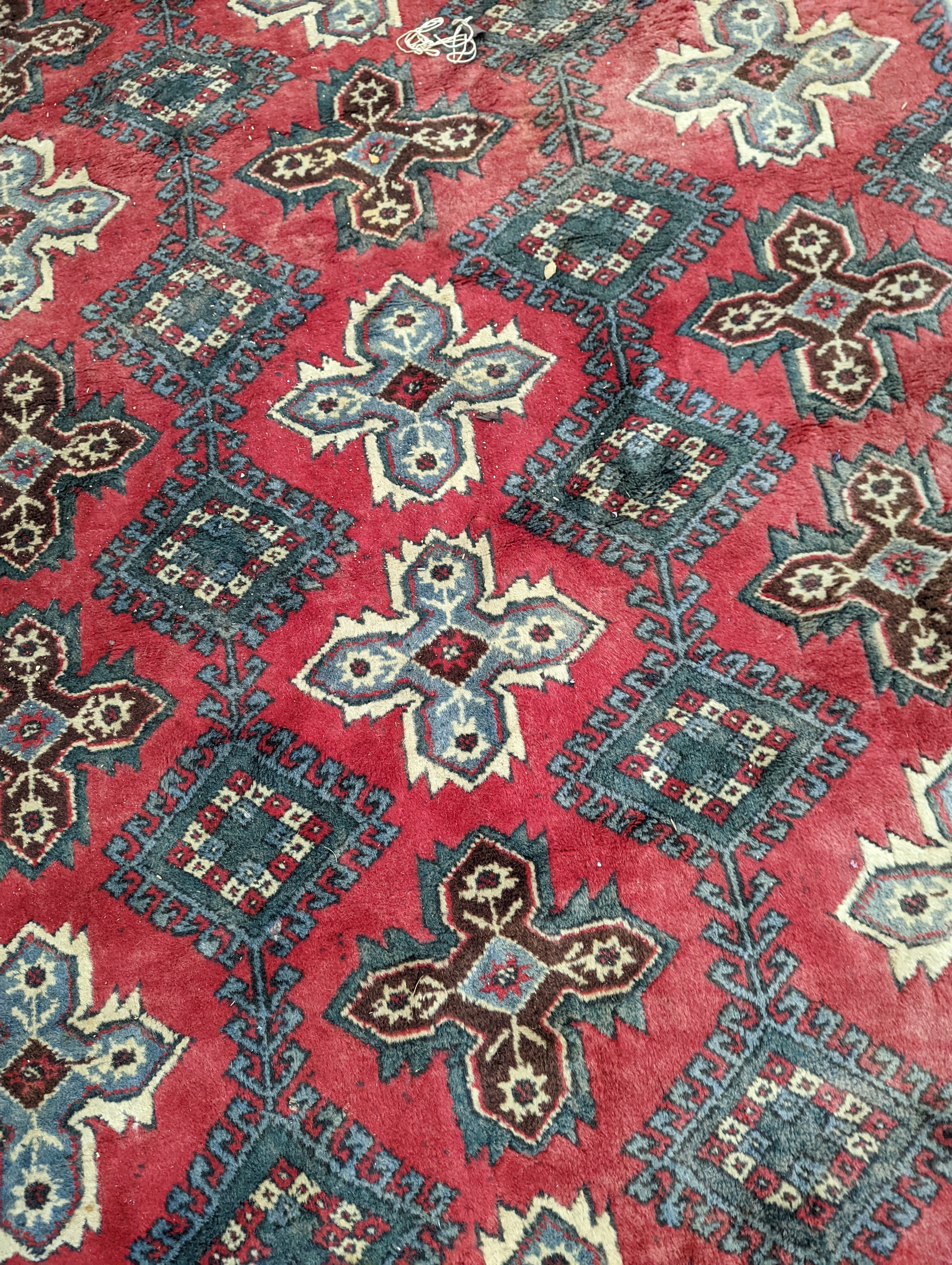 A Caucasian style red ground carpet, 286 x 210cm